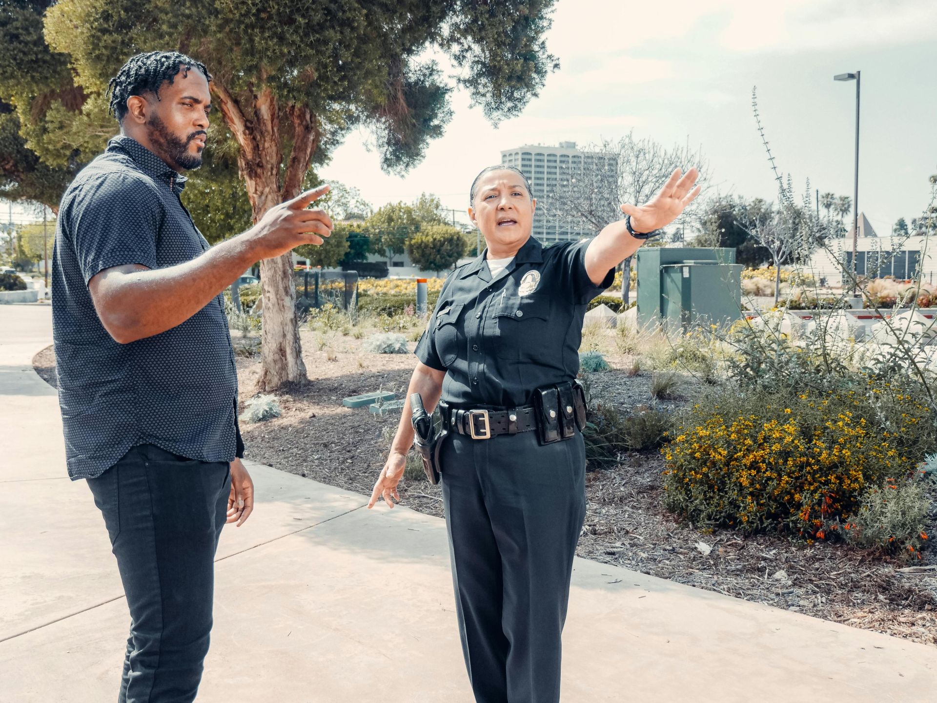 Police officer speaking with a man outdoors, showcasing community engagement.